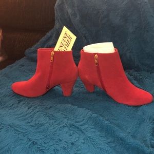 Ankle high red suede boots.